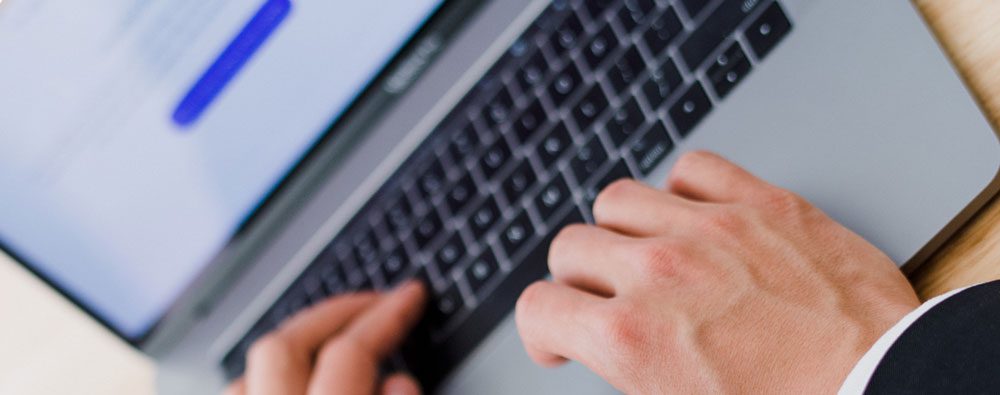 person typing on computer